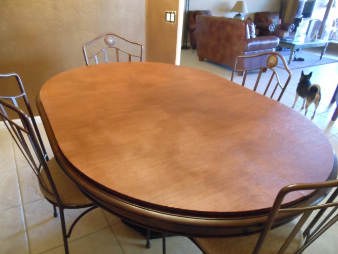 Palomino Leather Tone Table Pad on top of an oval kitchen dining table.